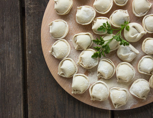 Raw Russian dumplings on the cutting board. 