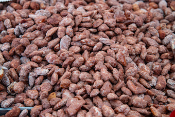 Praline peanuts for sale at the market. Sweet dessert for carnival parties, Christmas, Valentine's Day.