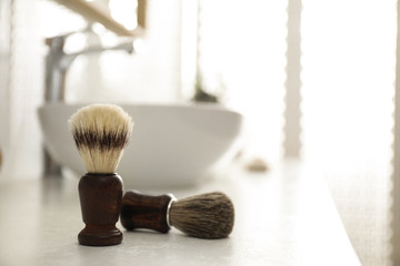 Pair of shaving brushes in modern bathroom interior