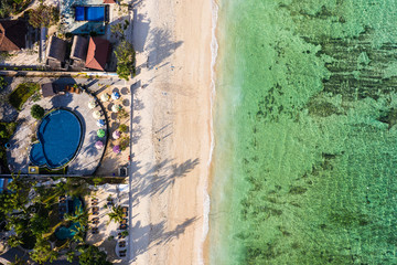 Top down view of Nusa Lembongan beach lined with resort and hotel in Bali, Indonesia