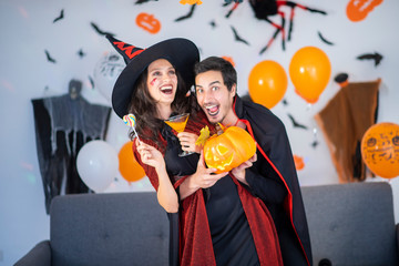 happy couple of love  in costumes and makeup on a celebration of Halloween