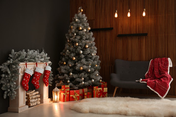 Stylish Christmas interior with decorated fir tree and fireplace