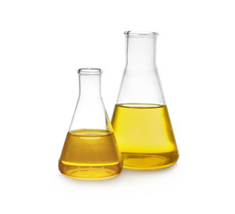 Conical flasks with yellow liquid on white background
