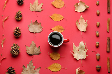Flat lay composition with cup of hot drink on red background. Cozy autumn atmosphere