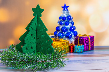 Merry Christmas New Year collection, gifts and decorative ornaments. Holiday Season background with decorations. Blue, green xmas trees. Gift boxes various colours. Copy space for text.