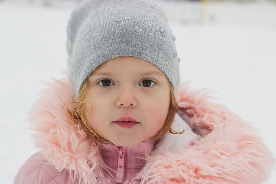 Beautiful little girl, looking at camera, winter portrait
