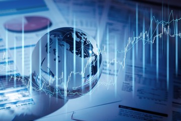 Glass globe with financial reports and graphs, toned image