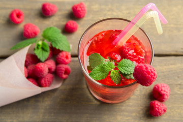 Glass of fresh strawberry summer cocktail and strawberries on the wooden background. Healthy food...