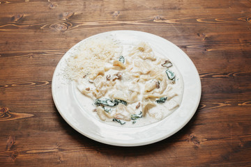Homemade tagliatelle with white sauce and spinach