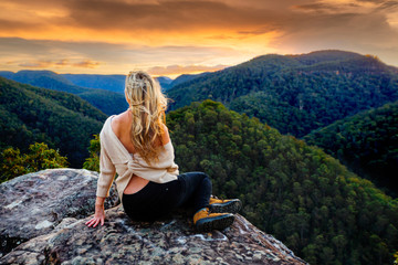 Woman mountain gazing at sunset