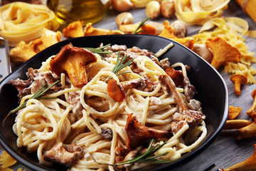 pasta with organic chanterelles. portion of spaghetti pasta with fried chanterelles in a creamy...