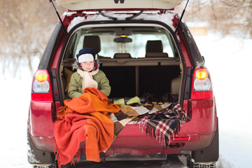 froze boy wrapped in blanket in the trunk of car