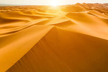 Fototapeta na wymiar Sunset over the sand dunes in the desert
