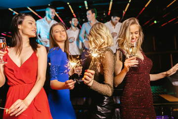 Group of friends partying in a nightclub