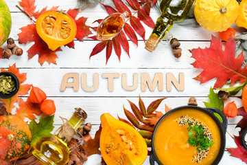 Autumn background with coffee, pumpkin, autumn leaves. flat lay. On a white wooden background. Top view. Free space for your text.