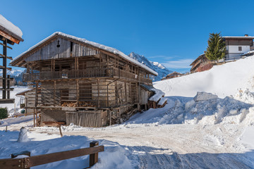 Fototapeta na wymiar Winter magic. The ancient wooden houses of Sauris di Sopra. Italy