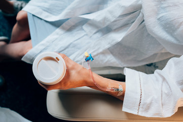 Hand of the woman with coffee in the hospital