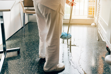 Concept photo of a hospital worker doing cleaning in the room