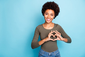 Photo of casual cute lovely sweet nice girlish feminine millennial woman wearing jeans denim green sweater smiling toothily showing you heart sign isolated over vibrant blue color background