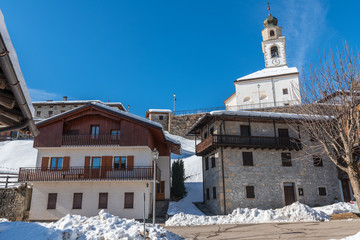 Fototapeta premium Winter in Sauris di Sotto. Magic of snow and old wooden houses. Italy