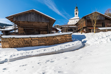 Winter in Sauris di Sotto. Magic of snow and old wooden houses. Italy