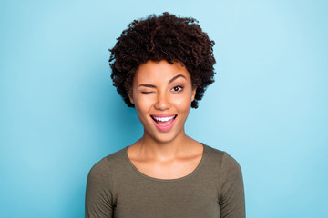 Close up photo of cheerful candid afro american girl wink blink have free time with her friends...