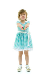 Little girl holding a ball on outstretched hands