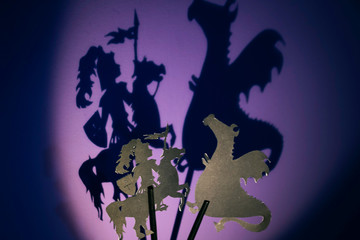 Silhouettes of a knight and a dragon fighting