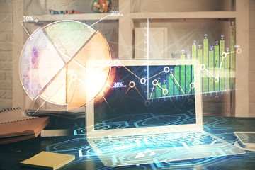 Double exposure of chart and financial info and work space with computer background. Concept of...