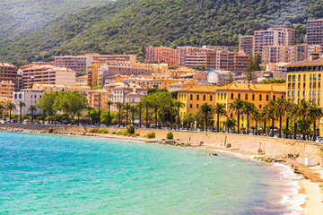 Ajaccio public beach with tourists at sunny day. Summer landscape of Corsica island