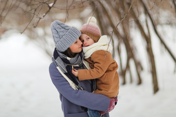 Fototapeta na wymiar Caucasian mother holding daughter in winter