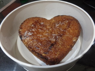 Heart shaped lemon drizzle cake in a round tin