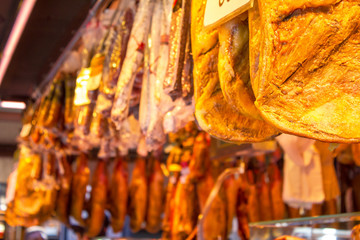 air dried Jamon, traditional spanish pork legs, hanging at the market store 