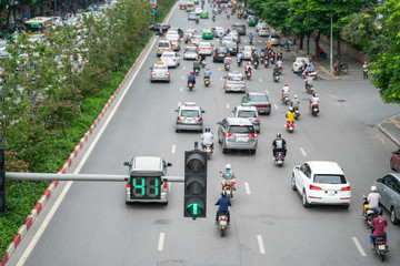 Traffic light with street traffic on background in Hanoi street