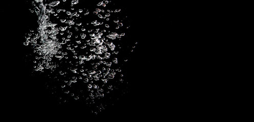 water splash with bubbles of air, isolated on a black background.