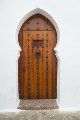  Old wooden door with brass decoration
