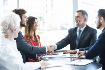 Business people shaking hands, finishing up a meeting.