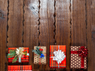 Obraz na płótnie Canvas Christmas gifts with christmas decoration on wooden background closeup