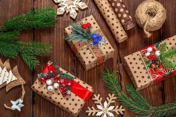 Naklejka na ściany i meble Christmas gifts with christmas decoration on wooden background closeup