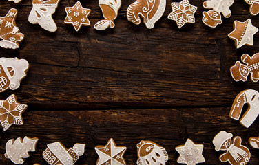 Christmas homemade gingerbread cookies on wooden table, top-down view.