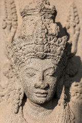 Ancient weathered female portrait statue carved out of stone in Jakarta, Indonesia