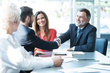 Business people shaking hands, finishing up a meeting.