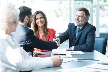 Business people shaking hands, finishing up a meeting.