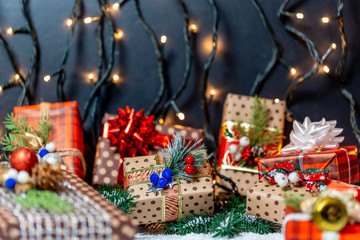 Christmas presents with branches Christmas tree on a snow. Christmas gifts on bokeh background