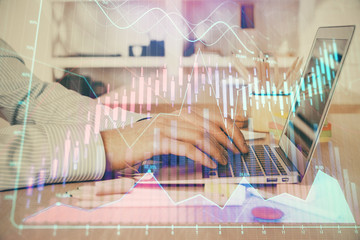Fototapeta na wymiar Double exposure of stock market graph with man working on laptop on background. Concept of financial analysis.