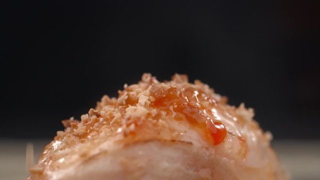 Sushi roll is sprinkled with grinded walnuts in slow motion, ooking sashimi, asian food restaurant, Full HD 240fps Prores HQ 10 bit