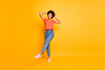 Fototapeta na wymiar Full length body size photo of charming cheerful attractive fascinating girlfriend black skinned wearing jeans denim t-shirt footwear going towards you isolated over yellow vivid color background
