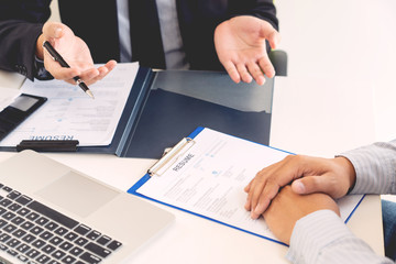 Job Interview and hiring concept, Appointment candidate Business man explaining about his profile and answer to Human resources manager sitting at a table opposite in the office