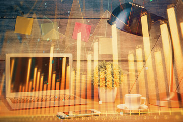 Double exposure of chart and financial info and work space with computer background. Concept of international online trading.
