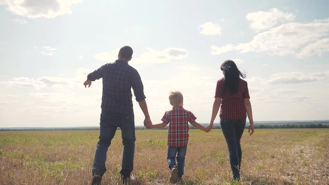 happy family walking nature teamwork friendship care concept slow motion video. father lifestyle mom and son walk in nature sunset sunlight hold hand. happy family parents man and girl hold little boy